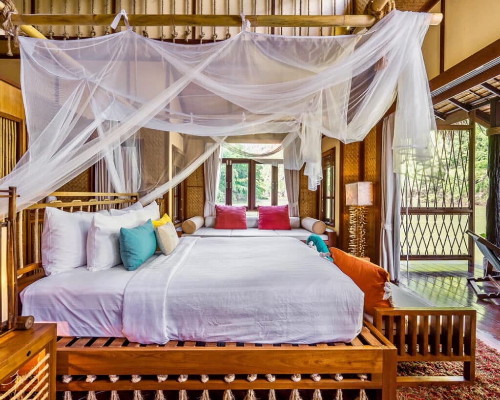 The interior of the Floating Villa at The FloatHouse River Kwai, distinguished by its Tropical Boutique design and vibrant colors.